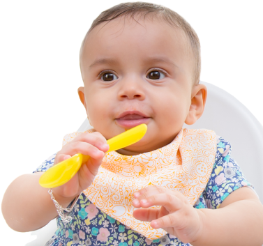 Baby smiling with spoon in hand
