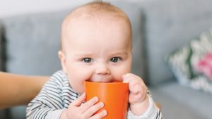Baby chewing a cup