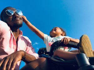 Toddler trying to take Dad's glasses