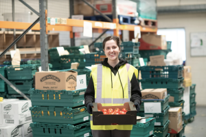 Woman in warehouse holding food