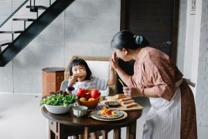 Mother hi-fives daughter