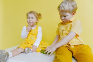 Two children wearing yellow
