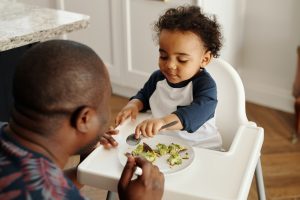 Father feeding toddler