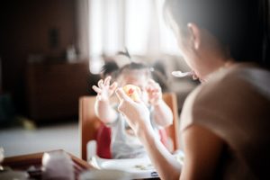 Mum feeding baby with spoon